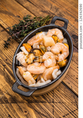 Ready for cooking fresh Raw Seafood Cocktail with Mussels, Clams, Prawns, Shrimps and squid in skillet. wooden background. top view Ready for cooking fresh Raw Seafood Cocktail with Mussels, Clams, Prawns, Shrimps and squid in skillet. wooden background. top view 126392690