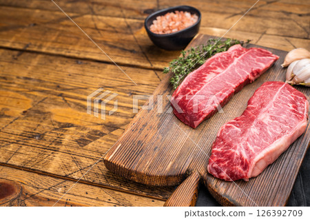 Raw Top blade steak, Fresh Beef shoulder Blade on wooden board. wooden background. top view 126392709