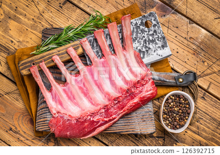 Butcher board with Raw lamb meat for chops steaks, fresh rack of mutton. wooden background. top view Butcher board with Raw lamb meat for chops steaks, fresh rack of mutton. wooden background. top view 126392715