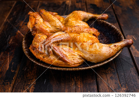 Baked chicken Tabaka Tobacco with spices, poultry meat on plate. wooden background. top view 126392746