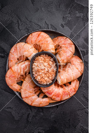 Plate with Headless Red Argentine shrimps, Prawns. black background. top view Plate with Headless Red Argentine shrimps, Prawns. black background. top view 126392749