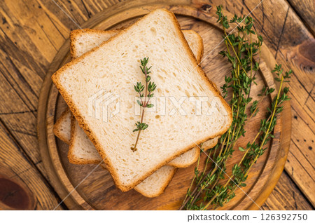 Ready for toasts Slices of wheat bread. wooden background. top view Ready for toasts Slices of wheat bread. wooden background. top view 126392750