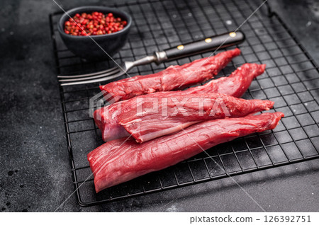 Raw lamb tenderloin fillet meat, fresh mutton. black background. top view 126392751