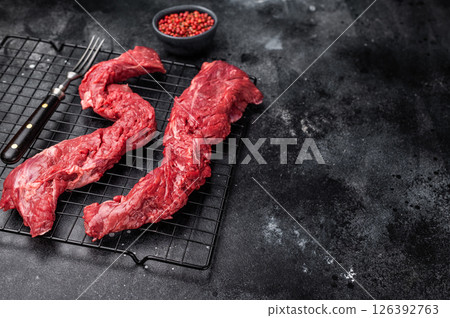 Raw Beef Steak Machete, uncooked meat . black background. top view 126392763