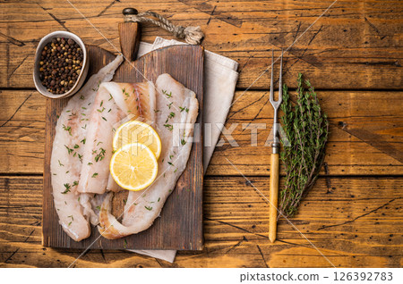 Haddock sea fish fillets, raw whitefish on a wooden board ready for cooking. wooden background. top view 126392783