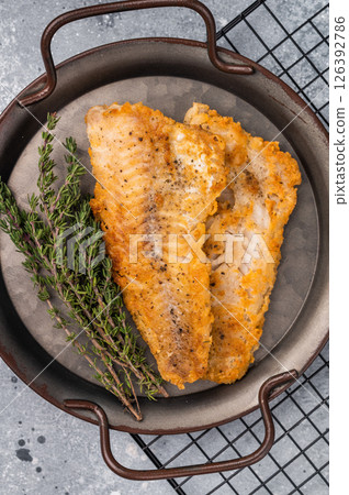 Fried pollock white fish fillet. grey background. top view Fried pollock white fish fillet. grey background. top view 126392786