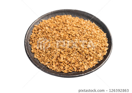 Dry buckwheat flakes in a plate isolated on white background. top view Dry buckwheat flakes in a plate isolated on white background. top view 126392863