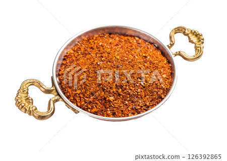 Red Chili pepper and paprika flakes in a skillet isolated on white background. top view Red Chili pepper and paprika flakes in a skillet isolated on white background. top view 126392865