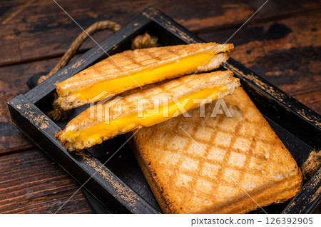 American hot Grilled cheese sandwich in wooden tray. wooden background. top view 126392905