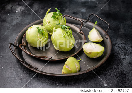 Raw kohlrabi on steel tray, Vegetable from Organic farm. black backround. top view Raw kohlrabi on steel tray, Vegetable from Organic farm. black backround. top view 126392907