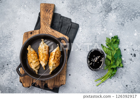 Fried Korean Dumplings with meat and vegetables in skillet. grey background. top view 126392917