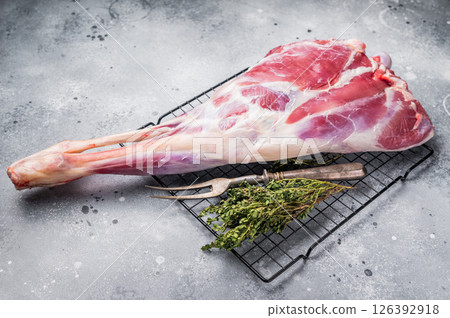 Raw whole goat leg, fresh meat. grey background. top view 126392918