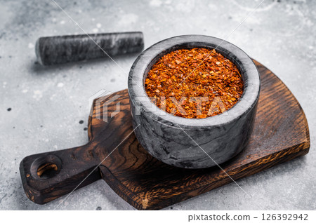 Cooking of Red Chili pepper and paprika flakes. grey background. top view Cooking of Red Chili pepper and paprika flakes. grey background. top view 126392942