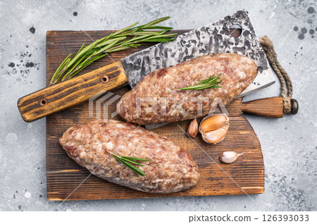 Succulent raw kofta kebab pieces marinated in spices, ideal for grilling enthusiasts looking to elevate their barbecue game. grey background. top view 126393033