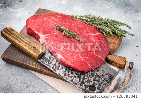 High quality raw top sirloin or rump beef steak, showcasing its rich flavor profile and tenderness, ideal for delicious meals. grey background. top view 126393041