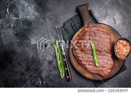 Grilled Flank Flap beef steak, showcasing beautiful grill marks. black background. top view Grilled Flank Flap beef steak, showcasing beautiful grill marks. black background. top view 126393047