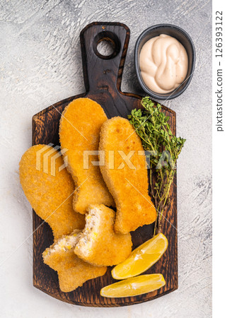 Deep fried Fish fingers on wooden board. white background. top view Deep fried Fish fingers on wooden board. white background. top view 126393122