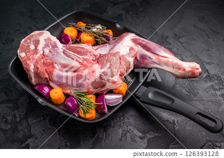 High quality raw lamb shoulder leg, an essential ingredient for hearty stews and savory dishes. black background. top view 126393128