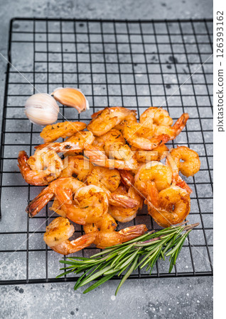 lavorful grilled prawns shrimps sizzling on the grill, inviting you to enjoy a taste of the ocean in every bite. grey background. top view 126393162