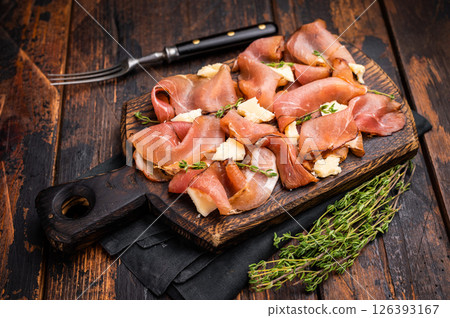 Italian Prosciutto parma ham with herbs and parmesan cheese on wooden board. wooden background. top view 126393167