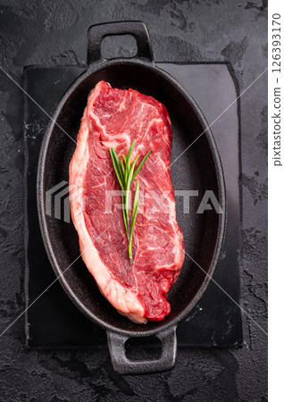 Premium raw striploin steak with rich color and texture, perfect for satisfying meat lovers at your next dinner. black background. top view Premium raw striploin steak with rich color and texture, perfect for satisfying meat lovers at your next dinner. black background. top view 126393170
