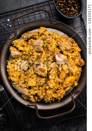 Arabic national rice food pilaf or plov, cooked with fried lamb and beef meat. black background. top view Arabic national rice food pilaf or plov, cooked with fried lamb and beef meat. black background. top view 126393171
