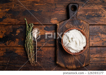 Dip sauce with Fresh Sour cream in a bowl. wooden background. top view Dip sauce with Fresh Sour cream in a bowl. wooden background. top view 126393177