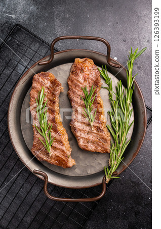 BBQ roast marbled beef Steak, beef meat on tray with herbs. black background. top view BBQ roast marbled beef Steak, beef meat on tray with herbs. black background. top view 126393199