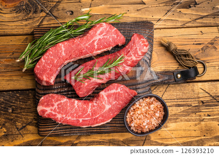Raw marbled beef Steak, beef meat on wooden board with herbs. wooden background. top view 126393210