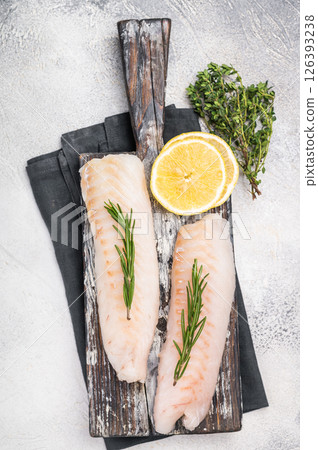Raw cod Loin, white fish fillets without skin on wooden board. white background. top view 126393238
