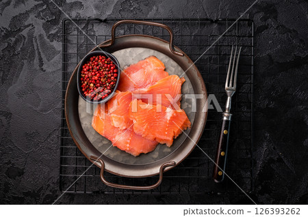 Salty salmon, trout fillet slices on steel tray. black background. top view 126393262