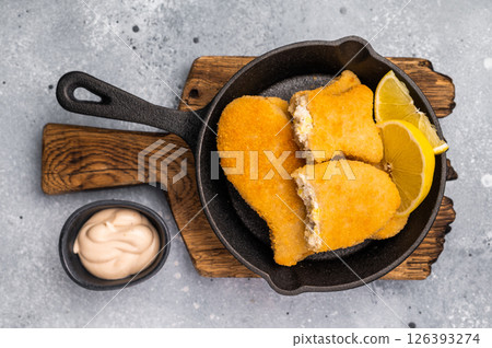 Breaded gold Fish sticks in pan. grey background. top view 126393274