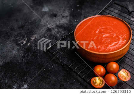 Canned Tomato sauce Passata, preserved paste for cookng. black background. top view Canned Tomato sauce Passata, preserved paste for cookng. black background. top view 126393310