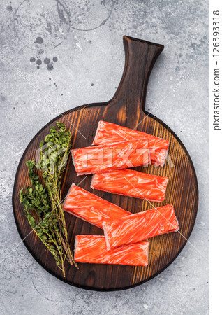Crab sticks, crabmeat on wooden board. grey background. top view 126393318