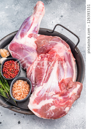 Whole fresh goat shoulder, inviting you to prepare a delicious roast that will impress your guests. white background. top view 126393331
