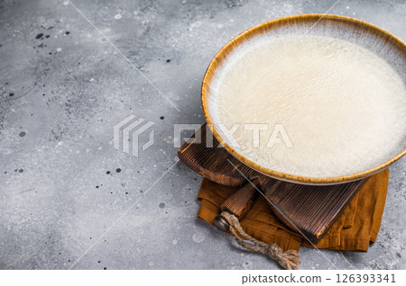 Clear Chicken Bouillon in a plate. grey background. top view Clear Chicken Bouillon in a plate. grey background. top view 126393341