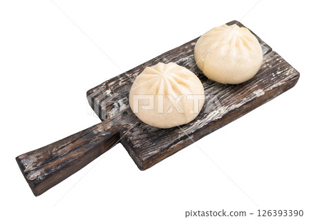 Traditional Dumpling Momos with meat on wooden board isolated on white background. top view Traditional Dumpling Momos with meat on wooden board isolated on white background. top view 126393390