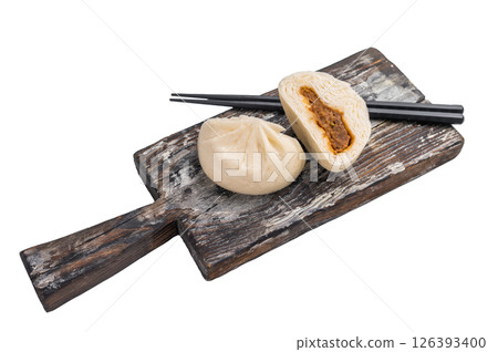 Chinese Steamed Bao bun with meat on wooden board isolated on white background. top view 126393400