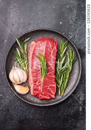 Australian Oyster Top blade steak, Fresh Beef shoulder meat on plate. black background. top view Australian Oyster Top blade steak, Fresh Beef shoulder meat on plate. black background. top view 126393628