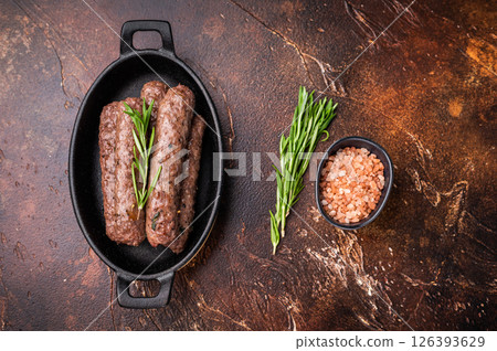 BBQ roast Turkish Urfa kebab with herbs. brown background. top view BBQ roast Turkish Urfa kebab with herbs. brown background. top view 126393629