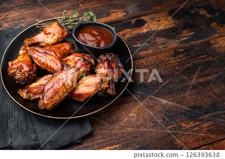 Deliciously sticky teriyakis sauce chicken wings, bursting with flavor, perfect for sharing at festive occasions or family dinners. wooden background. top view Deliciously sticky teriyakis sauce chicken wings, bursting with flavor, perfect for sharing at festive occasions or family dinners. wooden background. top view 126393638