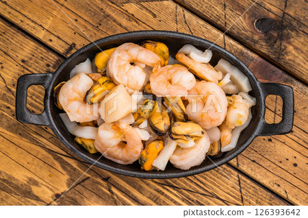 Ready for cooking fresh Raw Seafood Cocktail with Mussels, Clams, Prawns, Shrimps and squid in skillet. wooden background. top view Ready for cooking fresh Raw Seafood Cocktail with Mussels, Clams, Prawns, Shrimps and squid in skillet. wooden background. top view 126393642