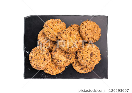 Oatmeal chocolate chip cookie on a marble board isolated on a white background Oatmeal chocolate chip cookie on a marble board isolated on a white background 126393697