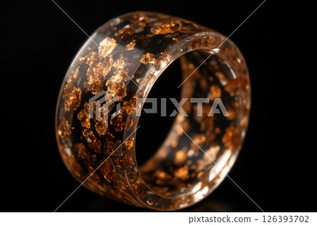 Close-Up of a Resin Ring with Gold Flakes and Dark Base 126393702