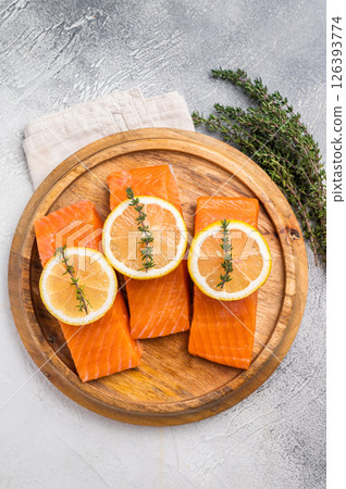 Fresh Salmon fillets, raw fish steaks. grey background. top view Fresh Salmon fillets, raw fish steaks. grey background. top view 126393774