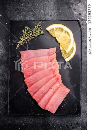 Premium quality tuna sashimi, ideal for a refreshing appetizer or light meal that delights the senses. black background. top view 126393789