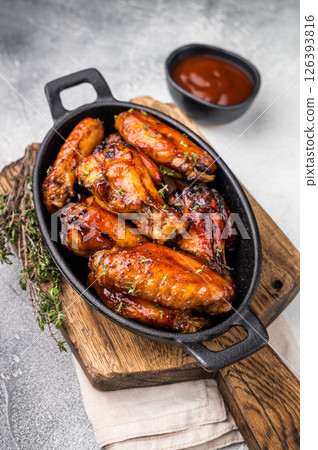 Grilled chicken wings smothered in sweet and sour sauce, poultry meat. white background. top view Grilled chicken wings smothered in sweet and sour sauce, poultry meat. white background. top view 126393816