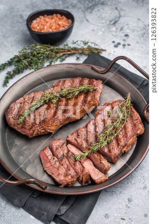 Roast Top blade steak, grilled beef shoulder meat. grey background. top view 126393822