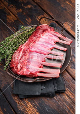 Fresh rack of lamb, raw mutton meat for chops steaks on steel tray. wooden background. top view 126393843
