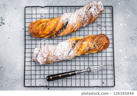 Danish pastry with Pistachios and chocolate, Puff pastry. grey background. top view Danish pastry with Pistachios and chocolate, Puff pastry. grey background. top view 126393849